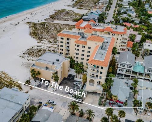 an aerial view of a beach with buildings and the words to the beach at Starfish Beach House in Clearwater Beach