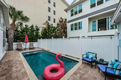 a swimming pool with a red swan in the middle at Starfish Beach House in Clearwater Beach