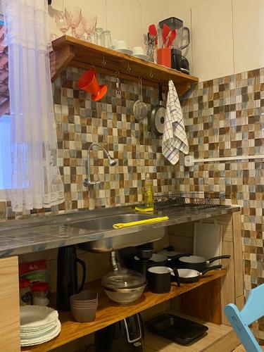a kitchen with a sink and a counter top at Ypê Hospedagem in Sao Jorge