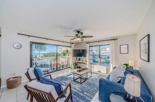 a living room with a blue couch and chairs at Hidden Beach Retreat in Clearwater Beach