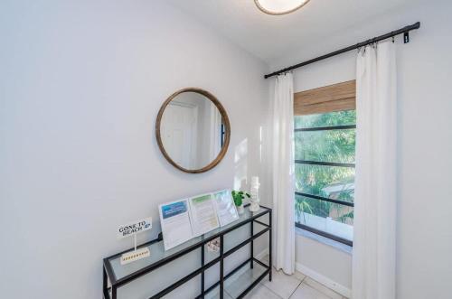 a hallway with a mirror and a window at Hidden Beach Retreat in Clearwater Beach