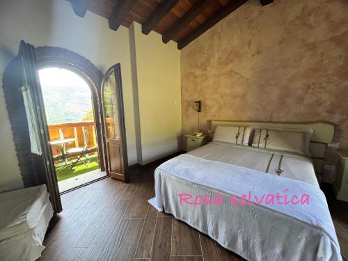a bedroom with a bed and an open window at B&B Bernacco in Vallio Terme