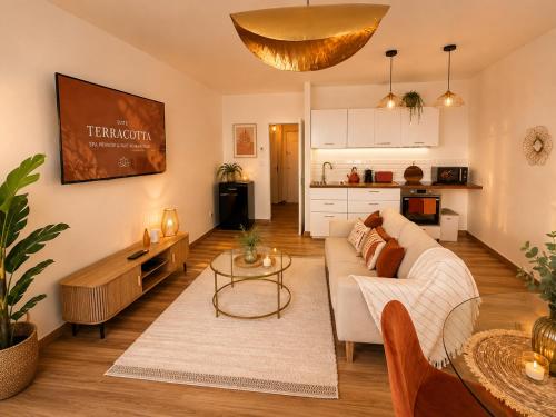 a living room with a couch and a table at Evasion Terracotta - Jacuzzi privatif in Saint-Gaudens