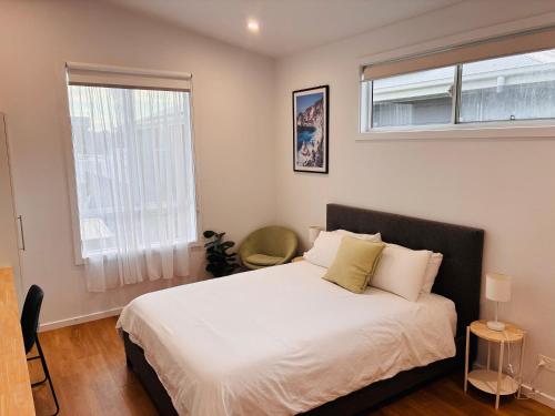 a bedroom with a large white bed with a window at Sapphire Beach Studio in Sapphire Beach