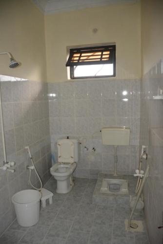 a bathroom with a toilet and a sink at Hotel Hills City, Swat in Mingāora