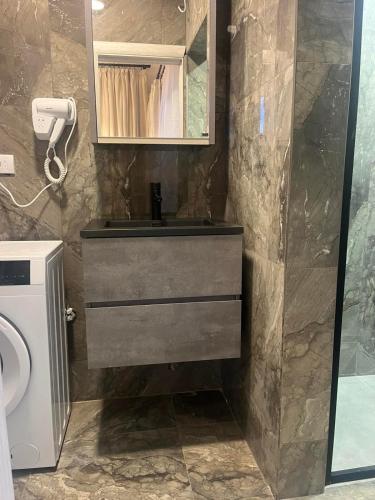a bathroom with a sink and a shower at Apartmani Vukotić in Budva