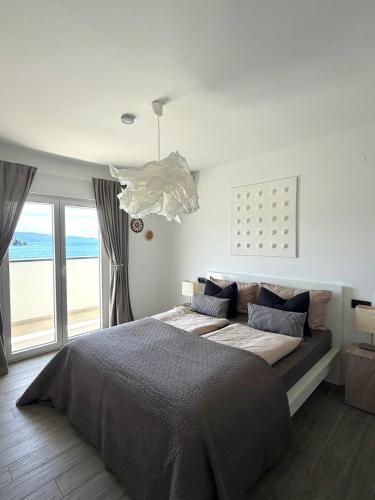 a bedroom with a bed and a large window at Villa Noma in Lovište