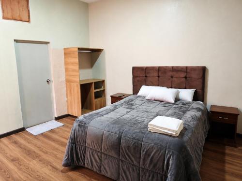 a bedroom with a large bed with a wooden floor at Gran Estancia Vallecito in Arequipa