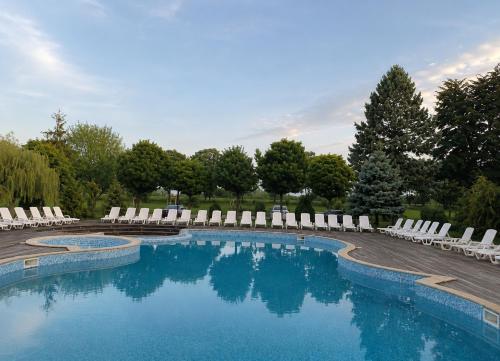 a swimming pool with lounge chairs and a swimming pool at Hipodruma Resort & Pool in Dobrich
