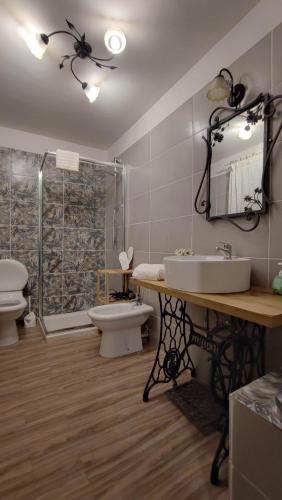 a bathroom with a sink and a toilet and a shower at Sicilia Bedda C&G in Acireale