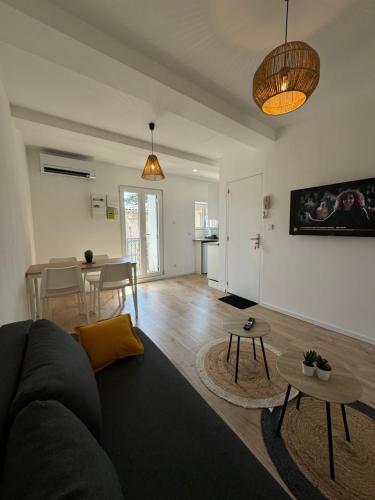 a living room with a couch and a table at Appartements Agde Cap d Agde in Agde