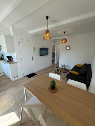 a living room with a table and a couch at Appartements Agde Cap d Agde in Agde