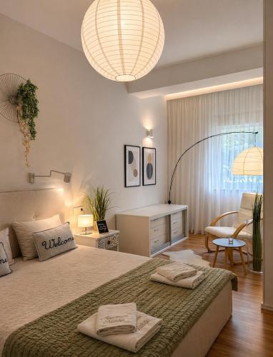 a bedroom with a large bed with two towels on it at Apartment Natasa in Rab