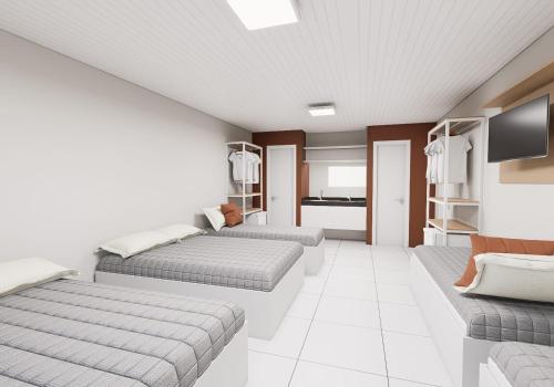 a room with two beds and a couch at Hotel JB in Juazeiro do Norte