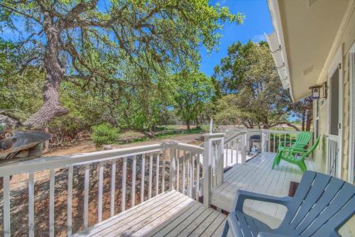 a deck with two chairs and a tree at CL 2459 Yellow Rose in Canyon Lake