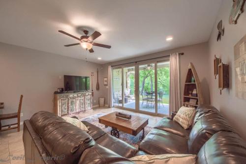 a living room with a leather couch and a table at RG 105 Rio Refuge in Canyon Lake