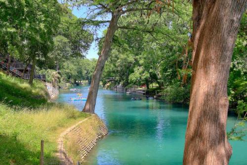 a river with a group of people swimming in it at CW C207 River Zen in New Braunfels