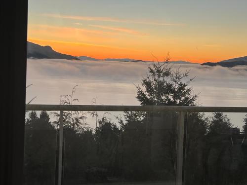 a view of the sunset from the balcony of a house at Vancouver sea view Palace inn in West Vancouver
