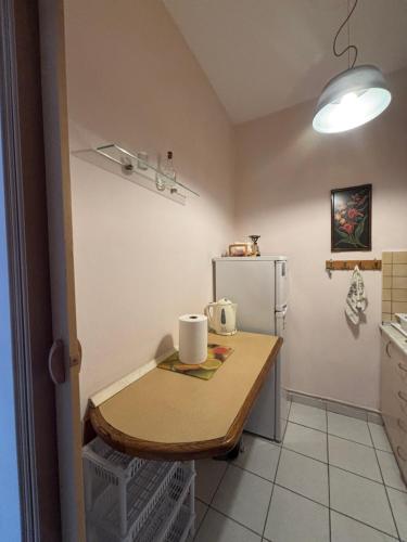 a small kitchen with a table and a refrigerator at Pieria Paralia Apartment in Paralia Katerinis
