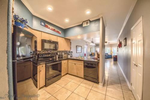 a large kitchen with stainless steel appliances and wooden cabinets at IC 112 Cowboy Corral in New Braunfels