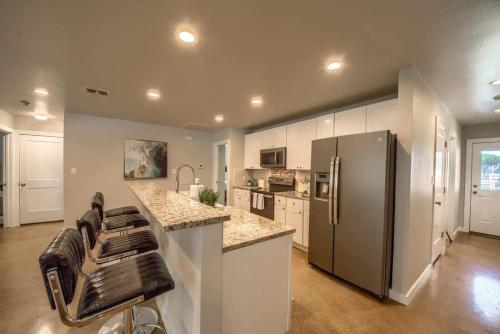 a kitchen with a refrigerator and a bar stool at RR 464 Sattler Haus in Canyon Lake