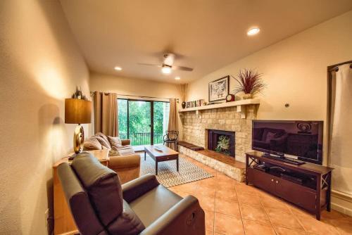 a living room with a couch and a fireplace at CW C109 River Bend in New Braunfels
