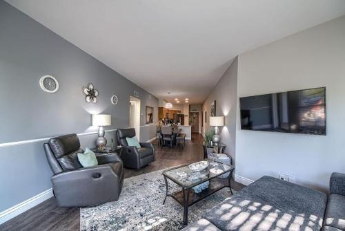 a living room with a couch and a tv at IC 316 Riverfront Bliss in New Braunfels