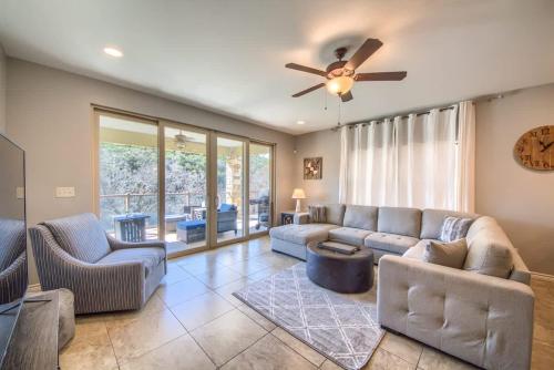 a living room with a couch and a ceiling fan at RG 306 Hillside River Retreat in Canyon Lake