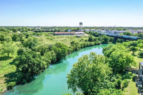 an aerial view of a river with a train on a bridge at SS B4 Riverside Condo in New Braunfels