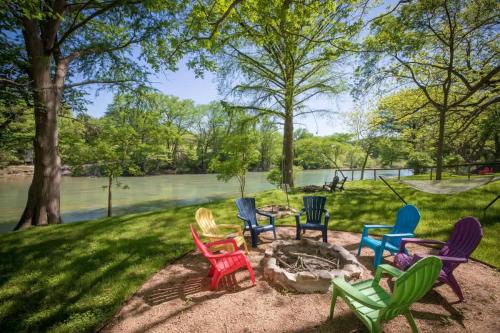 a group of colorful chairs sitting around a fire pit at RR 1300 Hondos River Haus in Canyon Lake