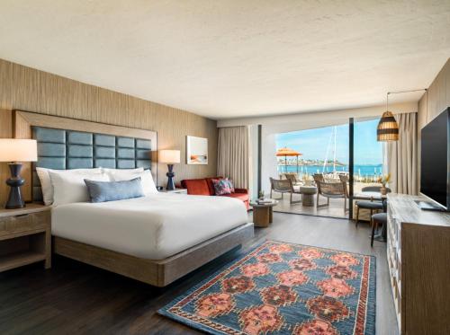 a bedroom with a bed and a view of the ocean at The Maya in Long Beach
