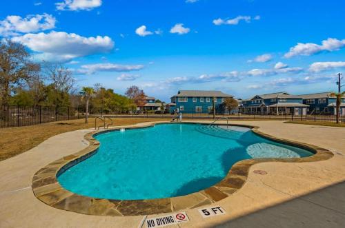 a swimming pool at a park with a house at OM A14 Gruene Bridge Bungalow at Old Mills Resort in New Braunfels
