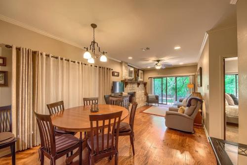a dining room and living room with a table and chairs at CW C113 Comal Vista in New Braunfels