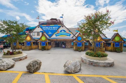 a building at a theme park with rocks in a parking lot at DT 534 Castle Shadow Cottage in New Braunfels