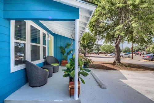 a blue house with a porch with a plant at DT 534 Castle Shadow Cottage in New Braunfels