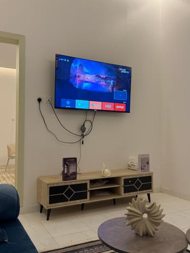 a flat screen tv hanging on a wall in a living room at وحده نجمة الفندقيه2 in Al Qurayyat