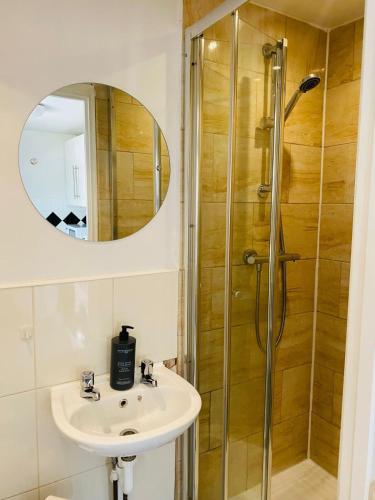 a bathroom with a sink and a shower at Cozy 1 bed city apartment in Peterborough