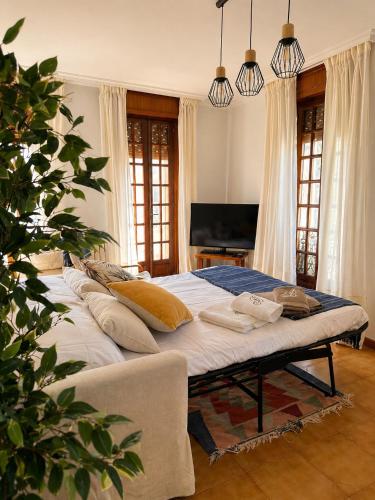 a large bed with pillows on it in a bedroom at Casa Bolumburu in Pontevedra