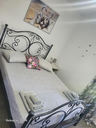 a bedroom with a bed with a metal bed frame at Estella in Naxos Chora