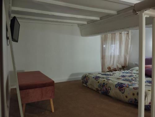 a bedroom with a bed and a chair and a beduteneway at Mariposa in Capodimonte
