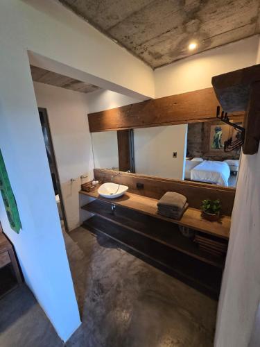 a bathroom with a sink and a large mirror at Linda Casa in Isla Tzilinabaj