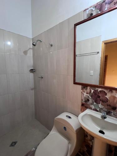 a bathroom with a toilet and a sink and a mirror at Estudio 201 Barrio blanco Estrato 5 in Cúcuta