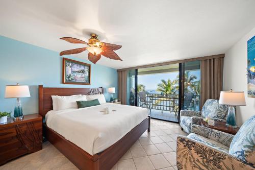 a bedroom with a bed and a balcony at Lahaina Shores 517 in Lahaina