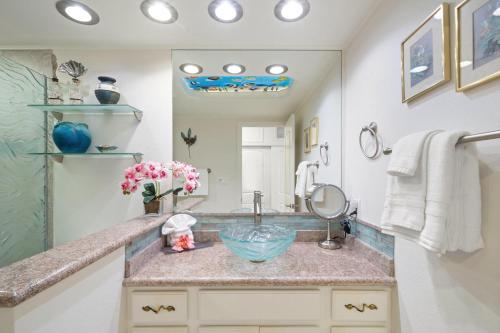 a bathroom with a sink and a large mirror at Lahaina Shores 517 in Lahaina