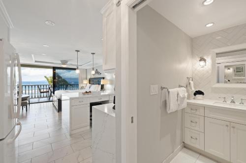 a white bathroom with a view of the ocean at Lahaina Shores 511 in Lahaina