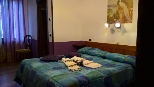 a hotel room with a bed with clothes on it at L'Ospitalità del Castello in Settimo Vittone