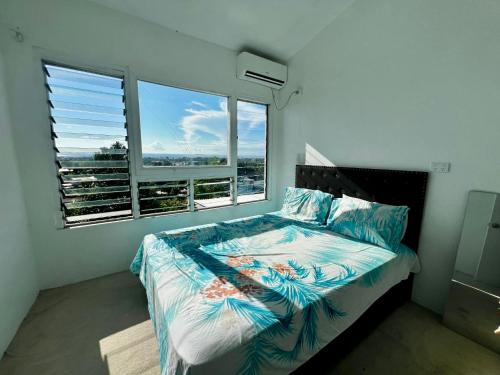 a bedroom with a bed and a large window at 3BR Oceanview Villas - Raisara Retreat, Central Suva in Suva