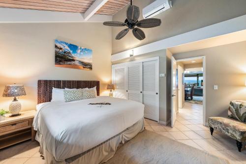 a bedroom with a bed and a ceiling fan at Kahana Village 4 in Lahaina