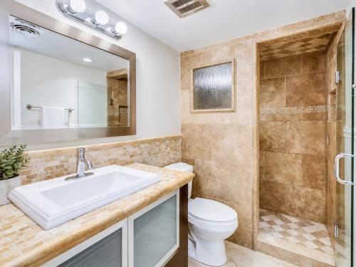 a bathroom with a sink and a toilet and a shower at Relaxing Condo with Parking - Minutes to Old Town! in Scottsdale