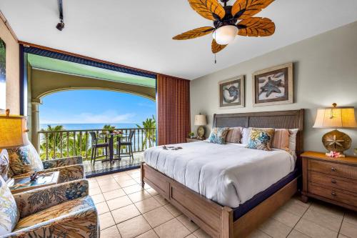 a bedroom with a bed and a balcony at Lahaina Shores 631 in Lahaina